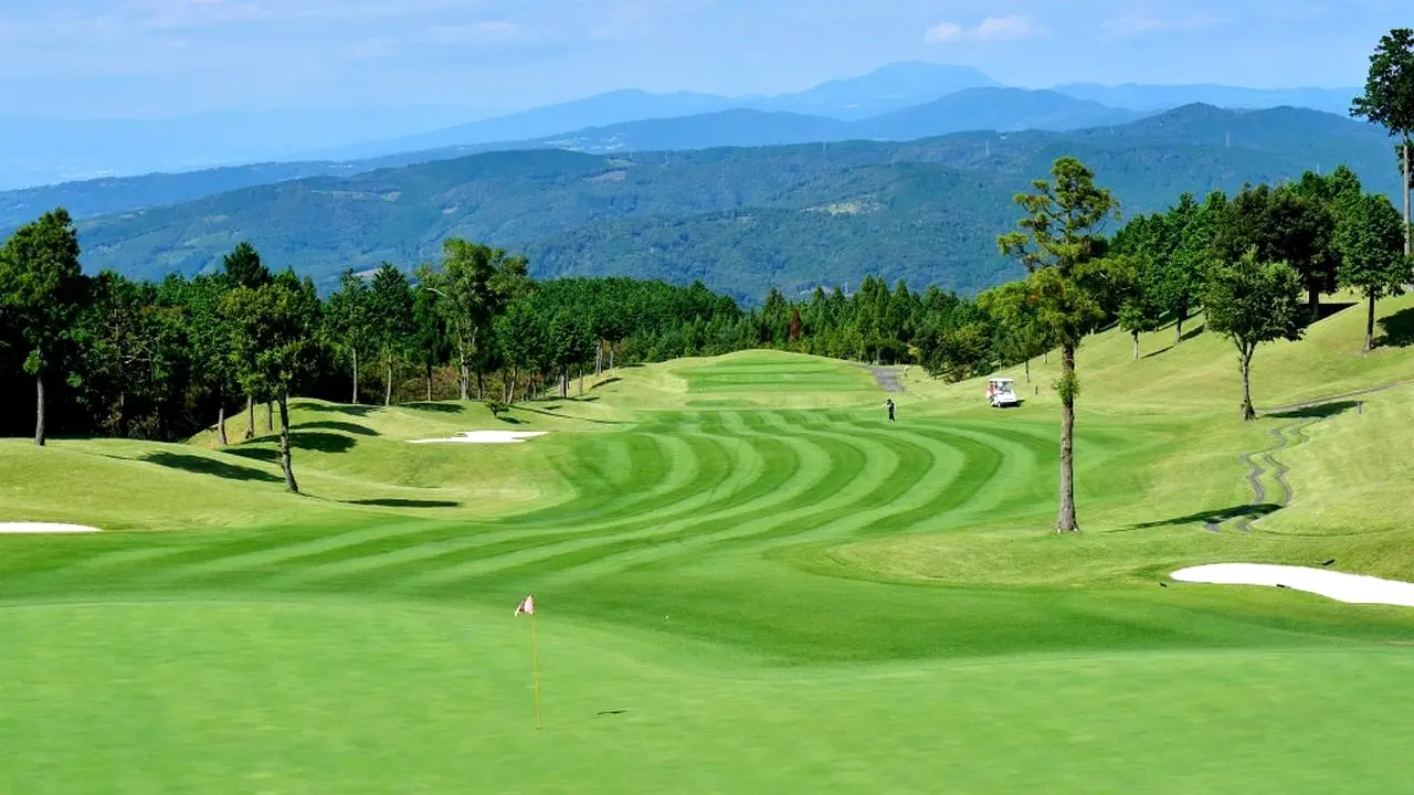 Striped fairway, green and mountain ridges at Nakaizu Green Club